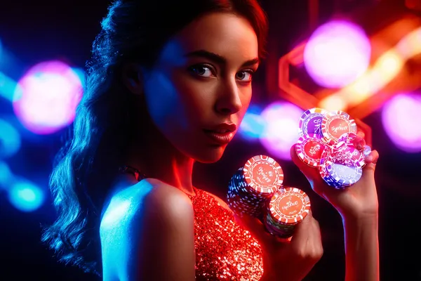 A glamorous woman holding casino chips in a neon-lit environment, representing the premium online casino atmosphere of K55GAME.